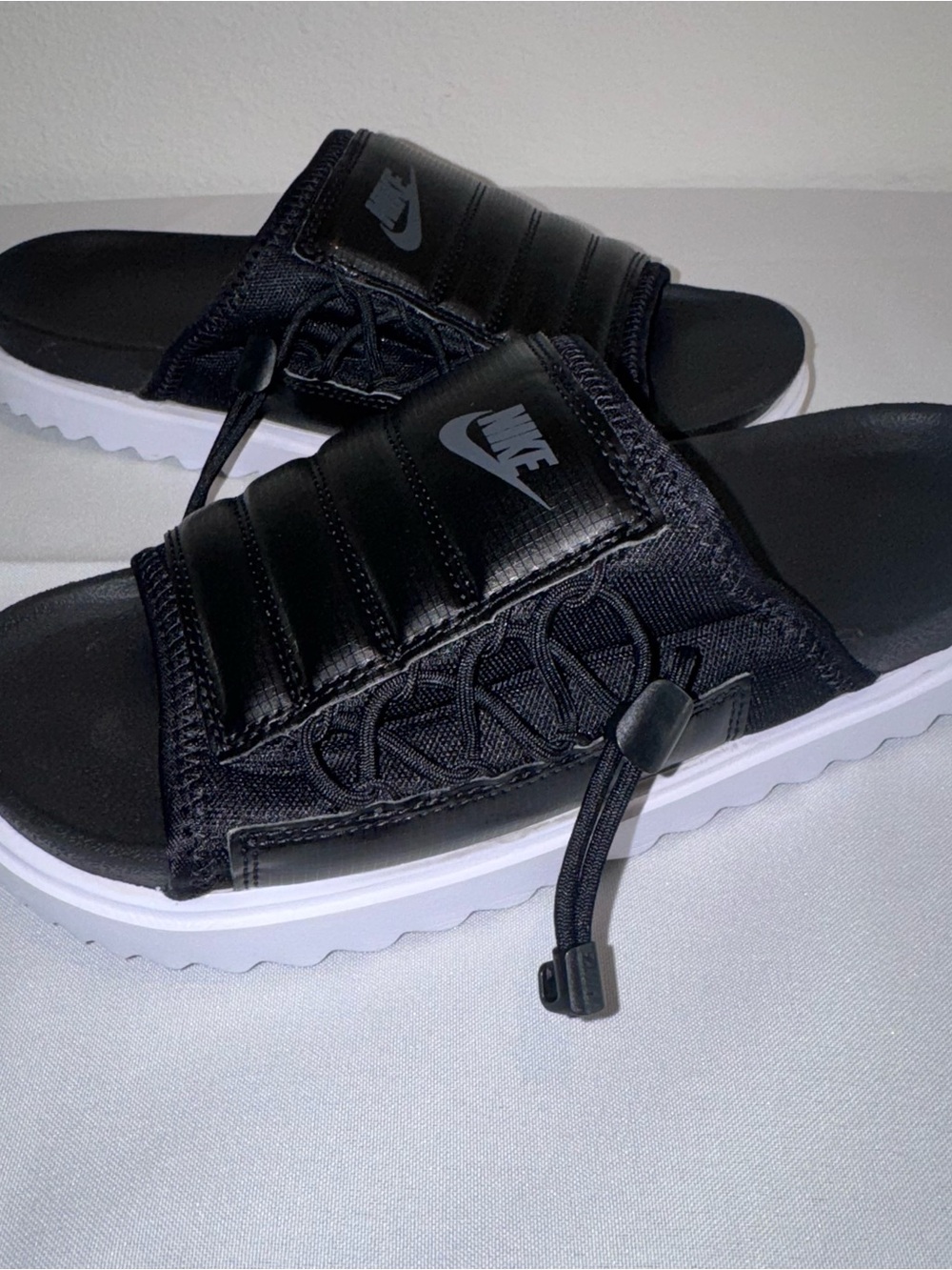Nike Black Slide Sandals with White Outsole and Adjustable Toggle